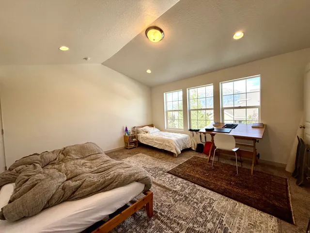 Room featuring multiple windows, recessed lighting, and a sloped ceiling detail