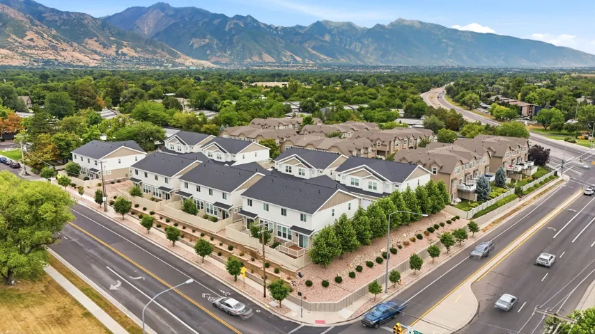 Modern townhomes featuring multi-level designs and dark shingle roofs