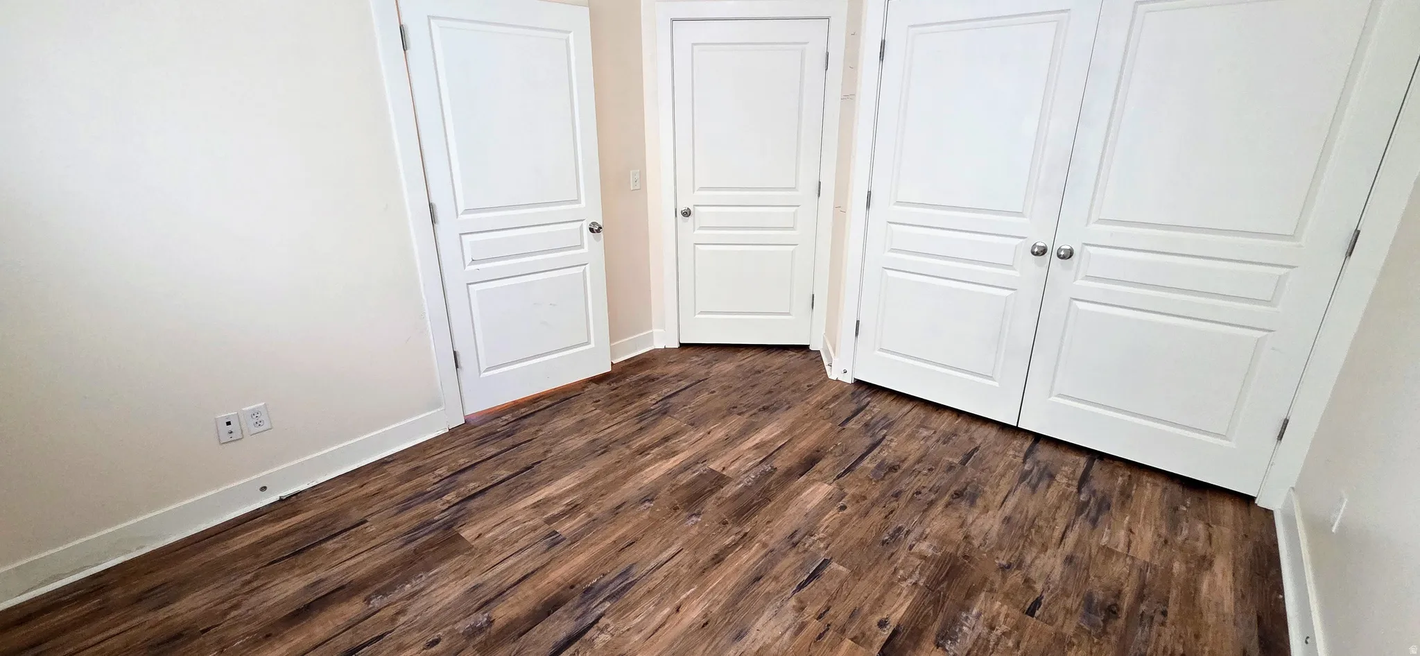Wood-finish flooring throughout, complemented by white baseboards and trim