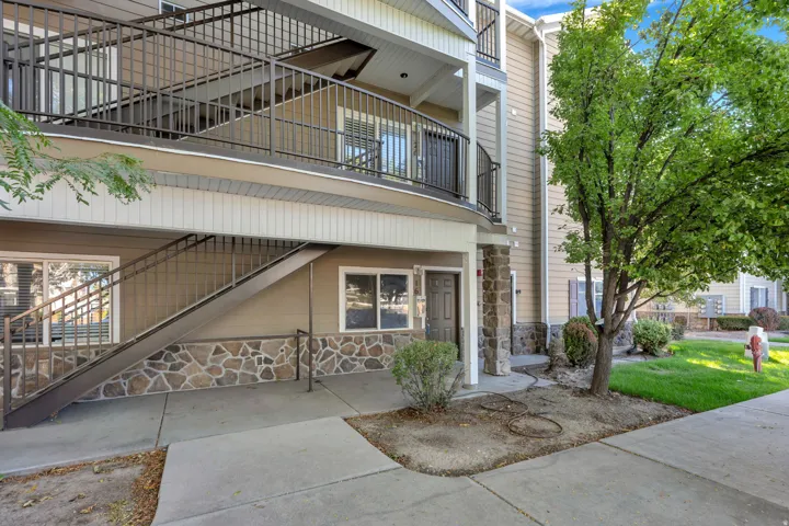 Exterior featuring multiple access points, stone veneer accents, and durable siding