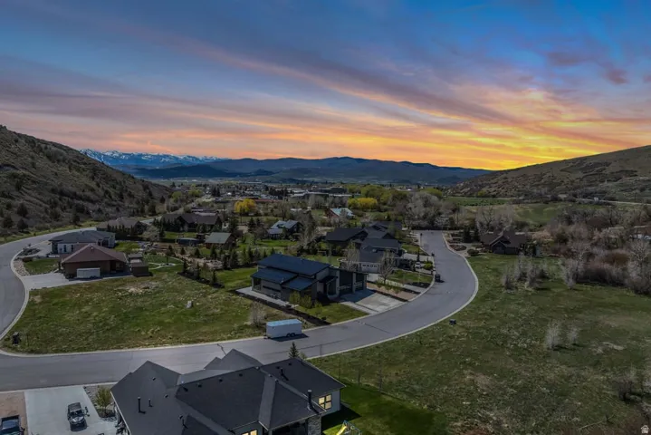 Aerial perspective of a developed residential area with paved streets and established homes