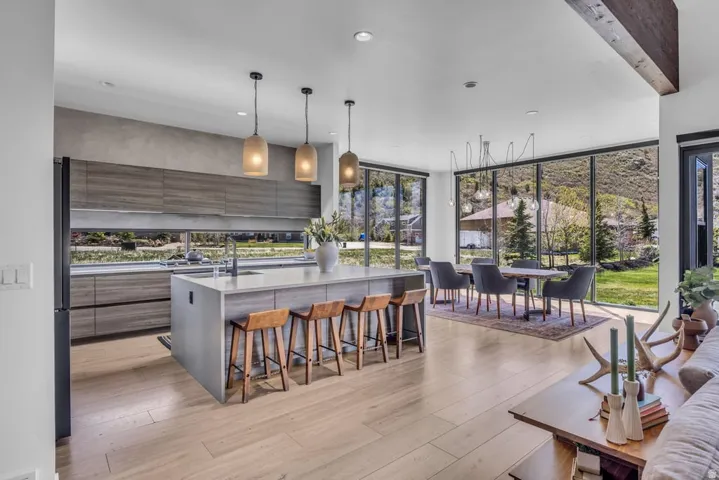 Open-concept living space with light wood-finish flooring
