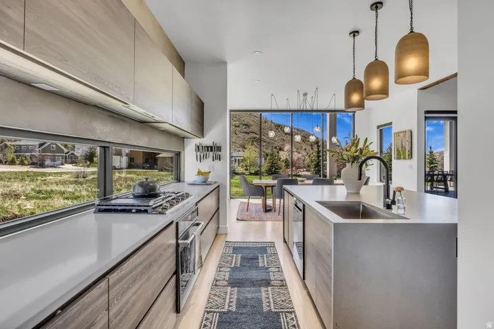 Modern kitchen featuring light wood-finish cabinetry and light countertops
