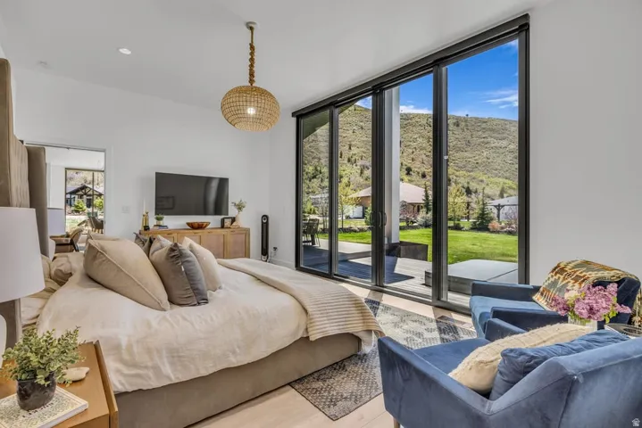 Sliding glass patio doors opening to a mountainous backdrop and a landscaped yard