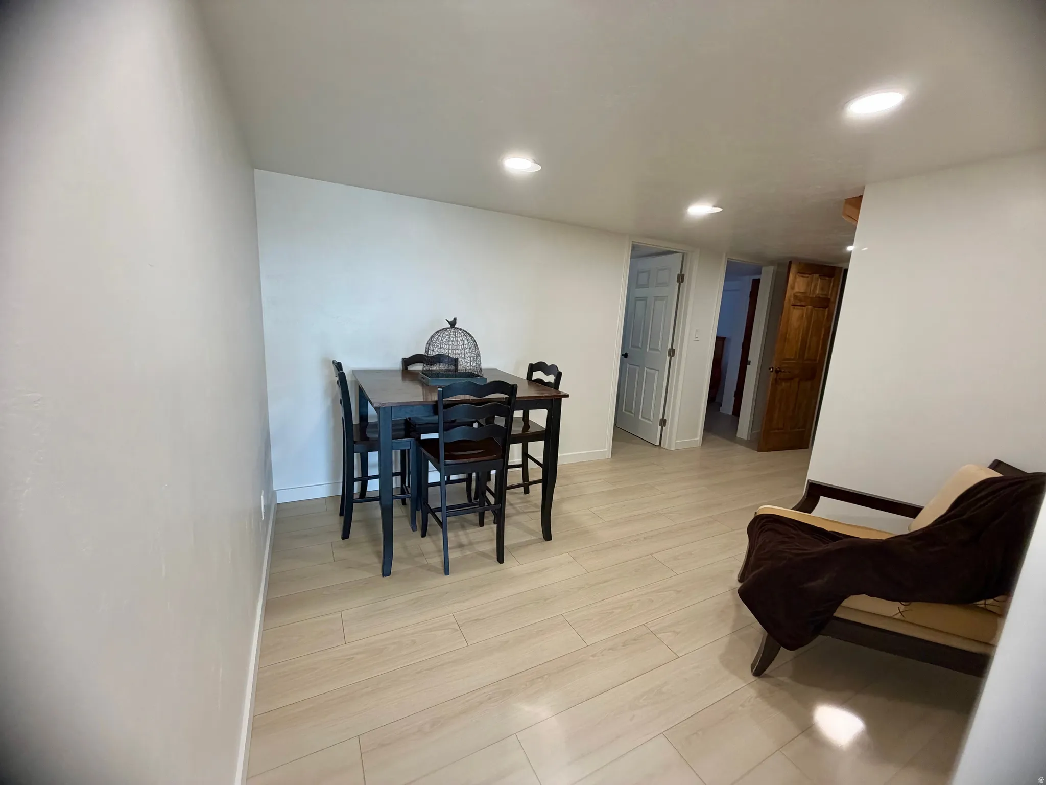 Light wood-finish flooring with recessed ceiling lighting