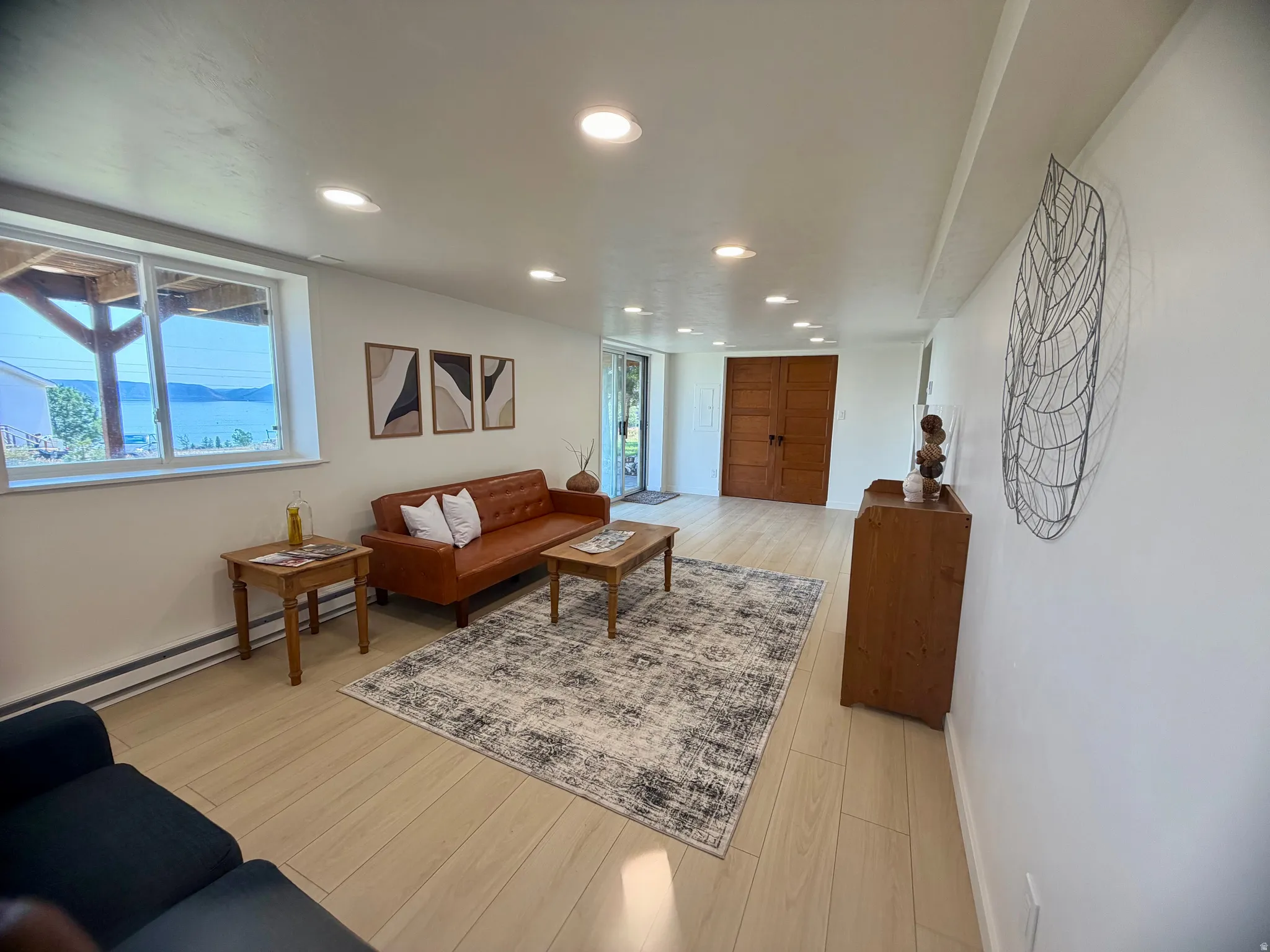 Bright living area featuring wood-finish flooring and recessed lighting