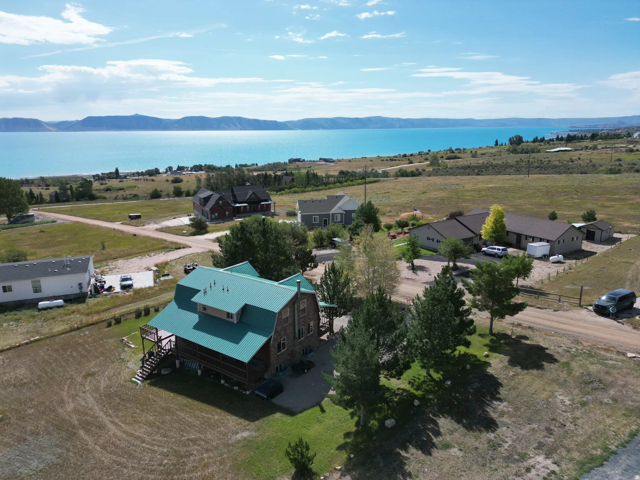 Expansive natural landscape featuring a large body of water and distant mountains