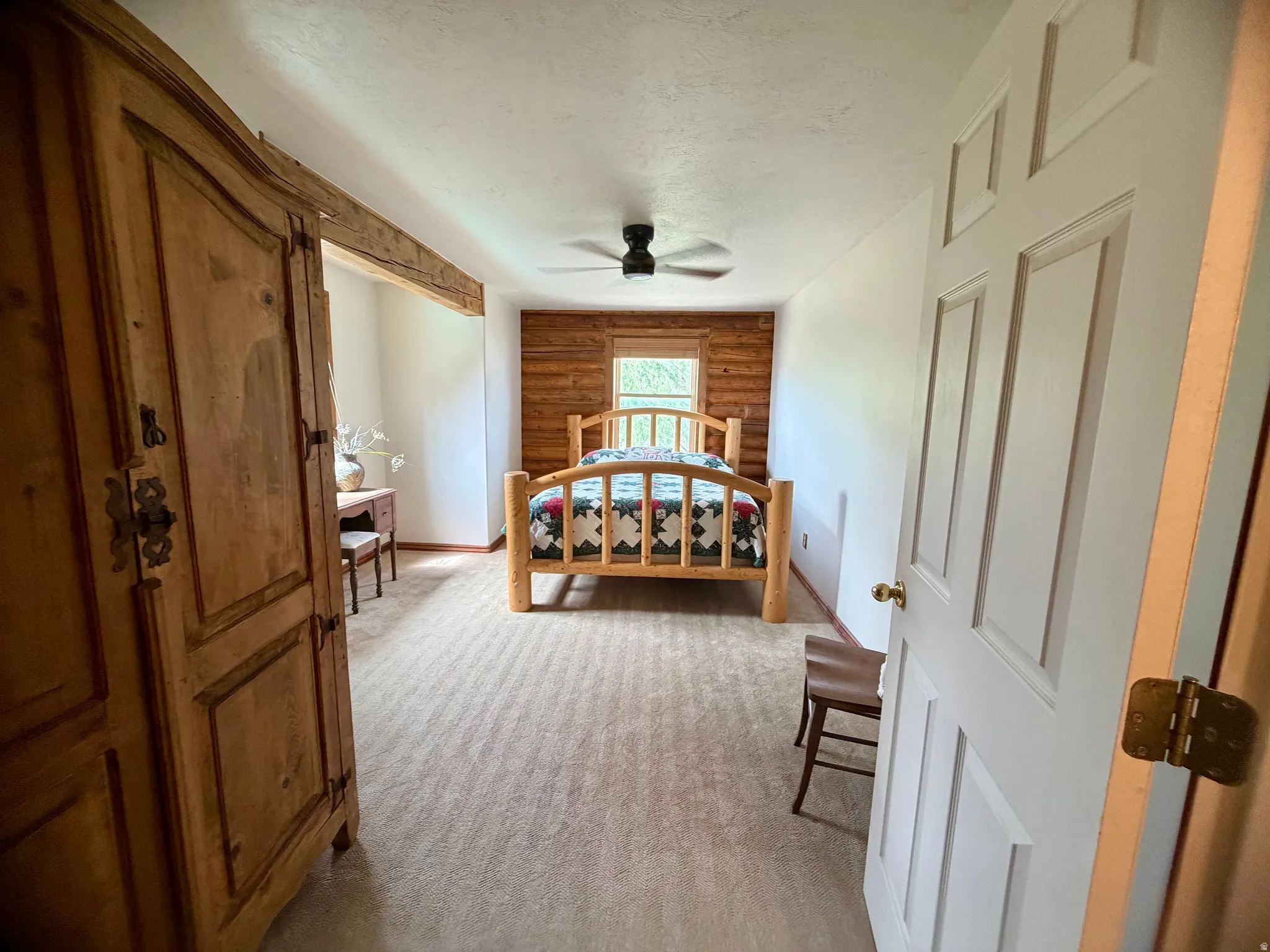Bedroom with light-toned carpet flooring
