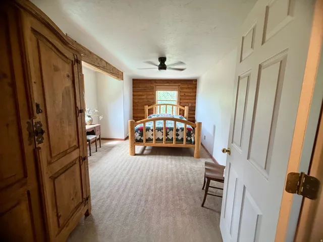 Bedroom with light-toned carpet flooring
