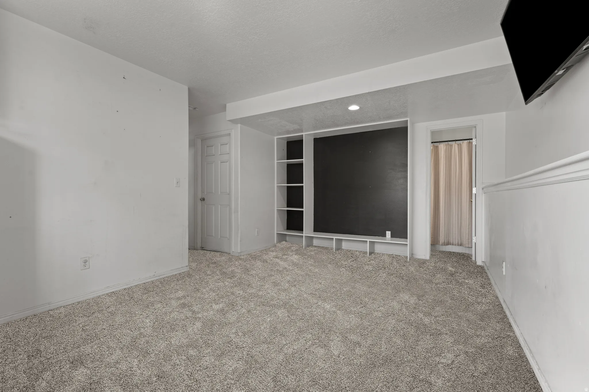 Carpeted room featuring a built-in media center with shelving, recessed lighting, and a neutral color palette. *Carpet is photoshopped in, ment to match new carpet.