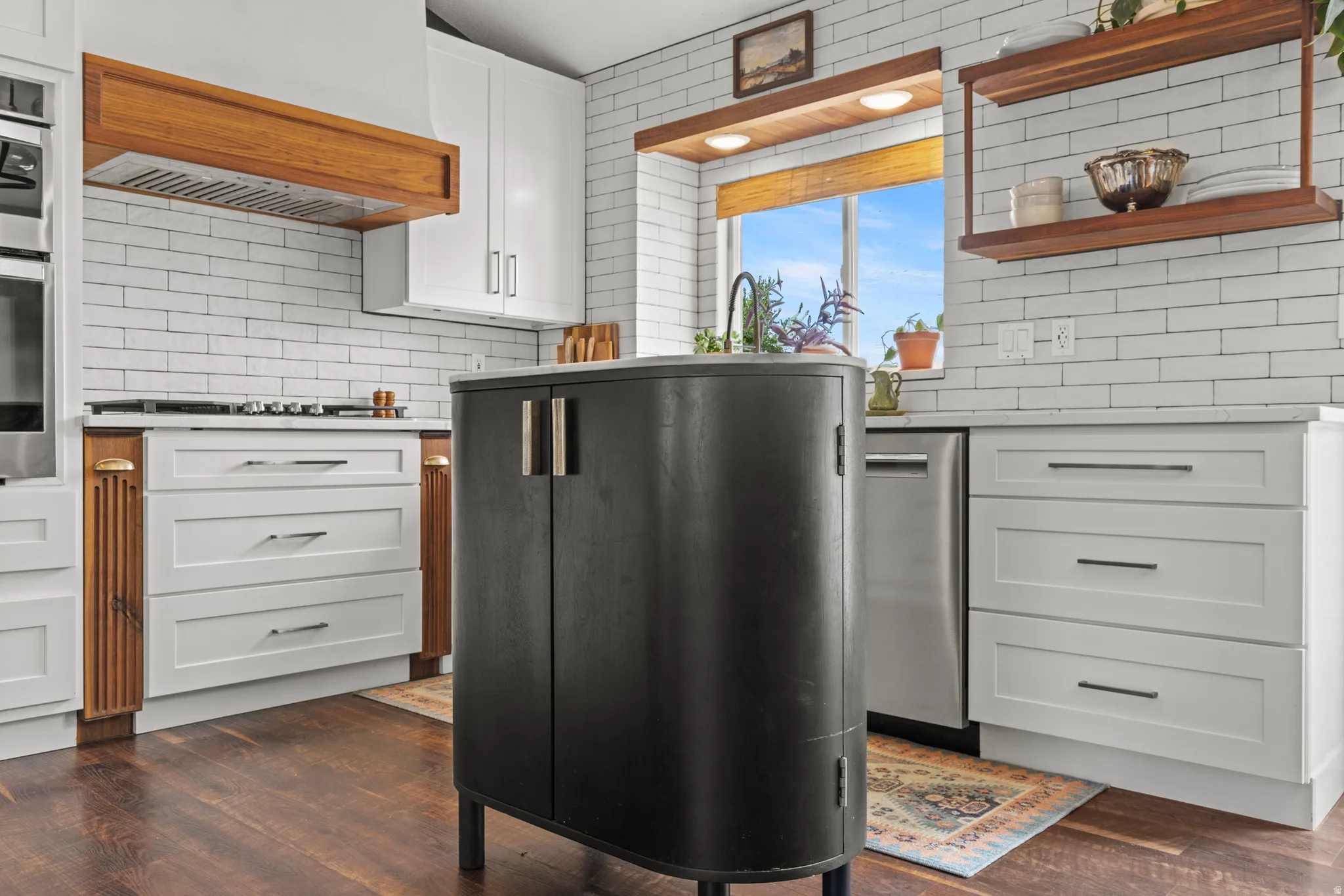 Gourmet kitchen featuring a built-in oven, gas cooktop, and white subway tile backsplash
