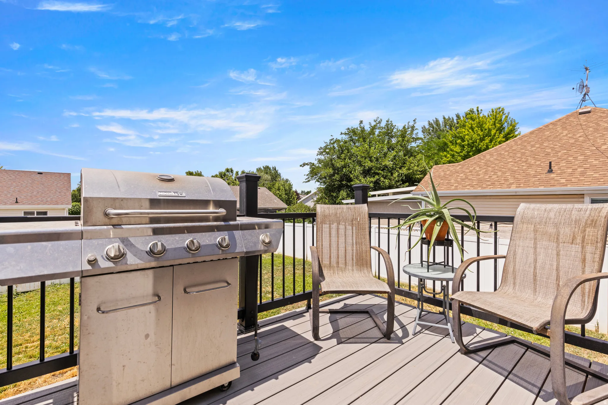 Outdoor deck featuring a composite surface, dark railings, and open-air design
