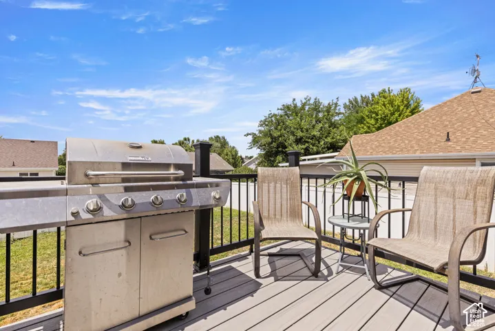 Outdoor deck featuring a composite surface, dark railings, and open-air design