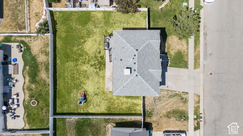 Expansive fenced backyard with a green lawn