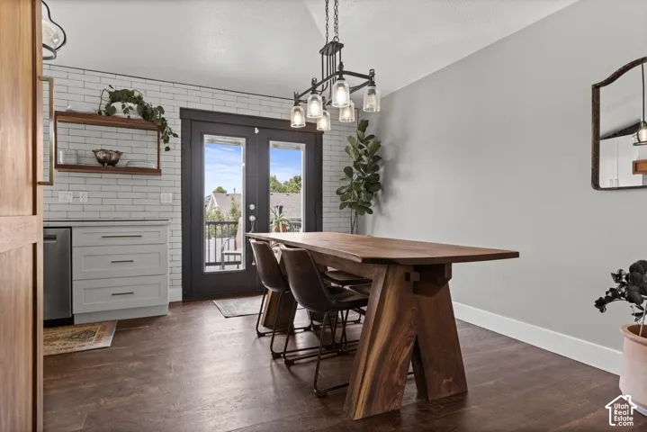 Dining space featuring wood-finish flooring and a contemporary linear chandelier