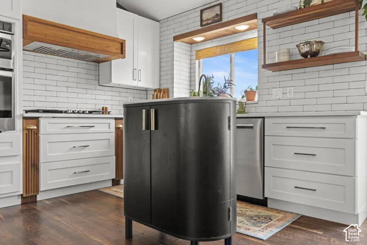 Gourmet kitchen featuring a built-in oven, gas cooktop, and white subway tile backsplash