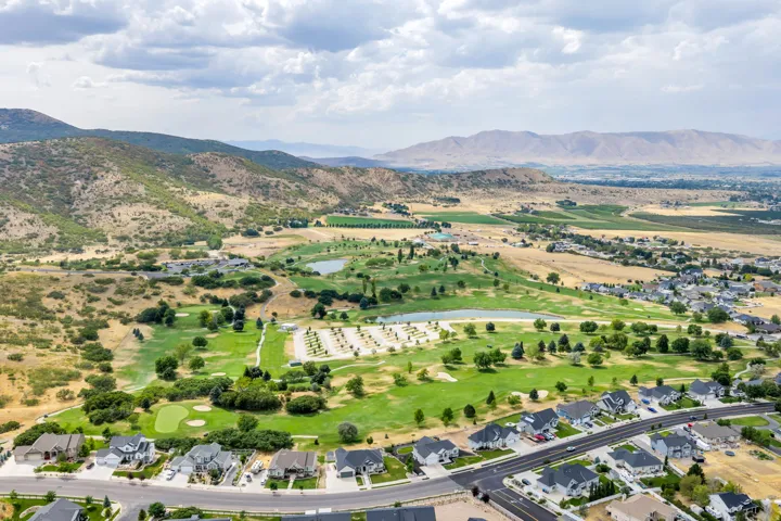 Expansive mountain landscape with a golf course, bodies of water, and residential properties