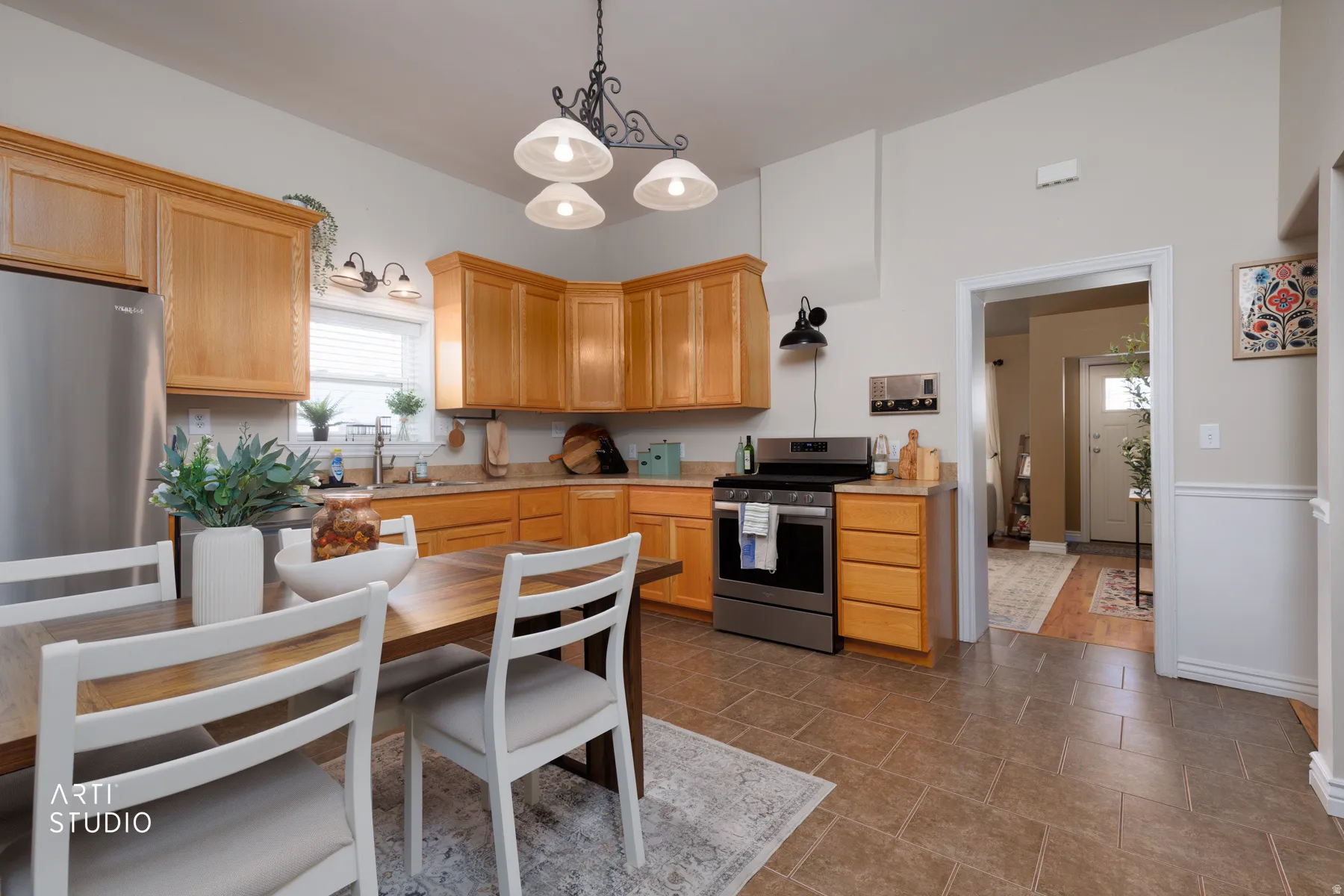 Bright kitchen with wood-finish cabinetry and stainless steel appliances
