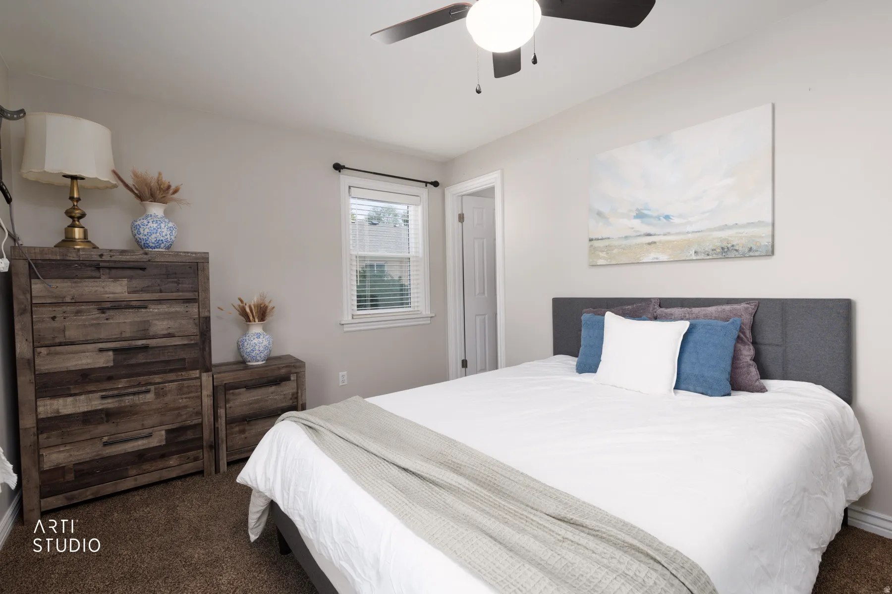 Bedroom featuring neutral wall paint, carpet flooring, a ceiling fan with integrated lighting, a window with blinds, and an interior door