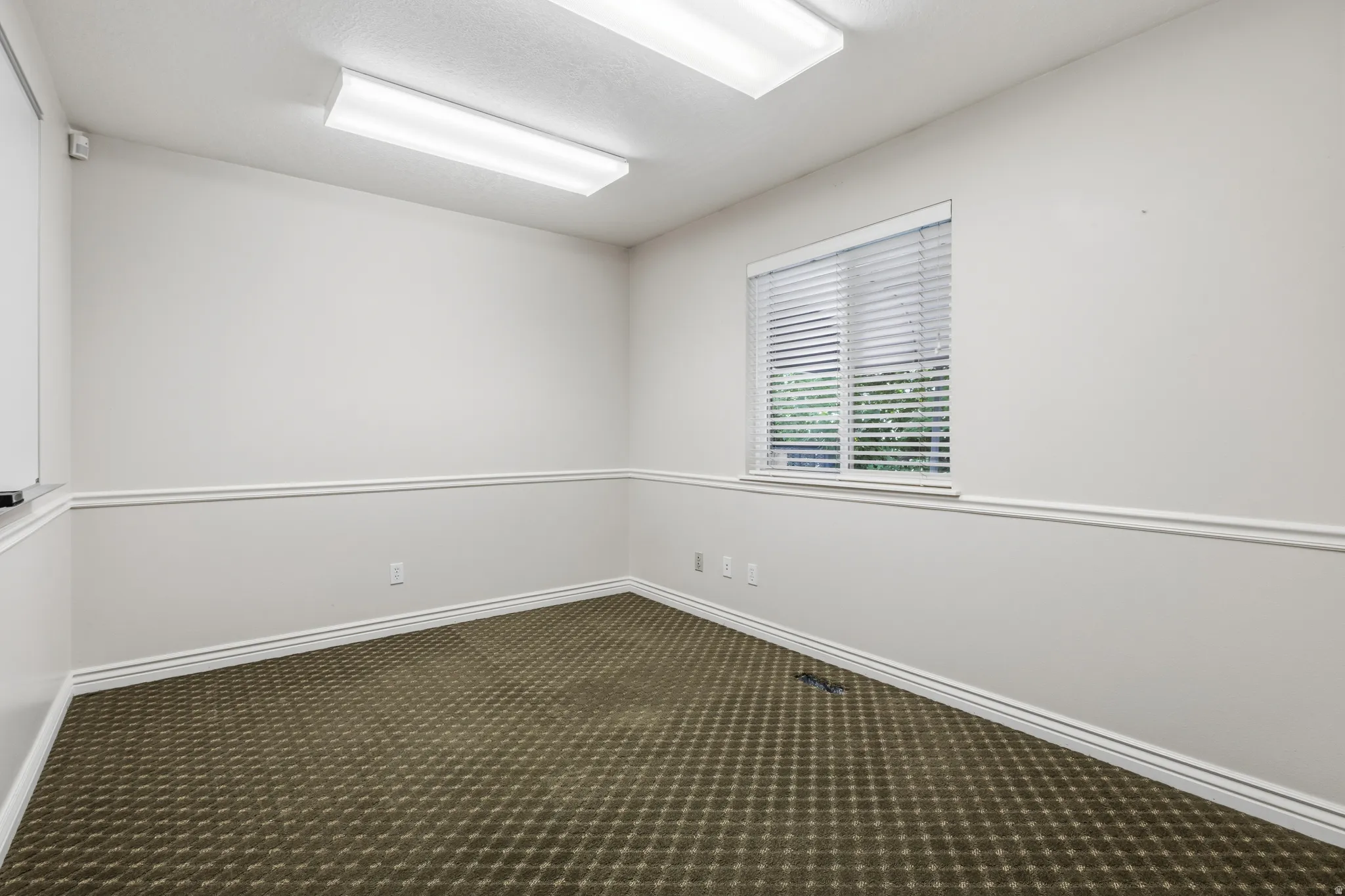 Neutral-toned walls featuring decorative chair rail molding