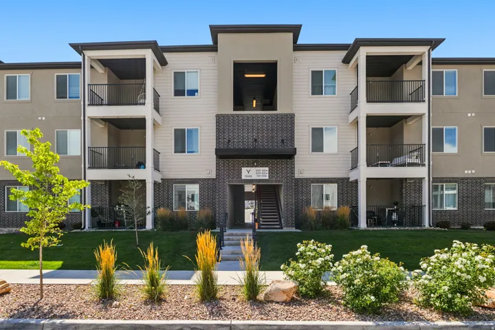Multi-story building exterior featuring vertical siding and dark brick accents