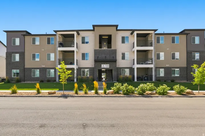 Multi-story apartment building featuring a modern facade with varying siding materials and colors