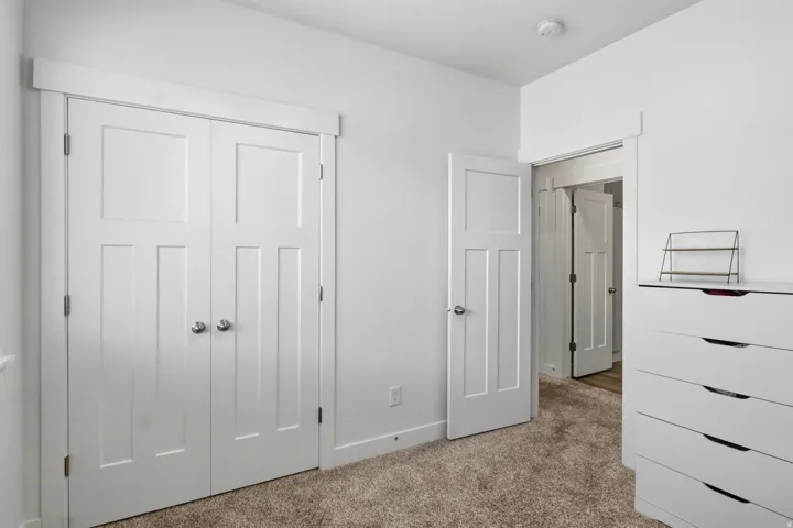 Plush carpeted flooring complementing crisp white trim and doors throughout