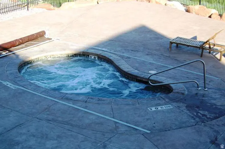 Inviting in-ground spa featuring a curved design and bubbling water