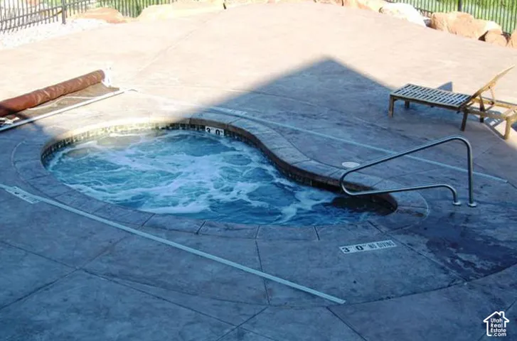 Inviting in-ground spa featuring a curved design and bubbling water