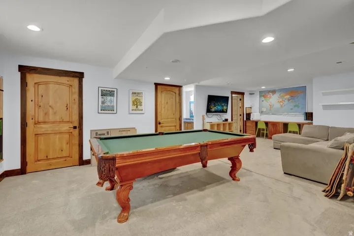 Recreation room featuring recessed lighting, a built-in media center, and two solid wood panel doors with dark trim