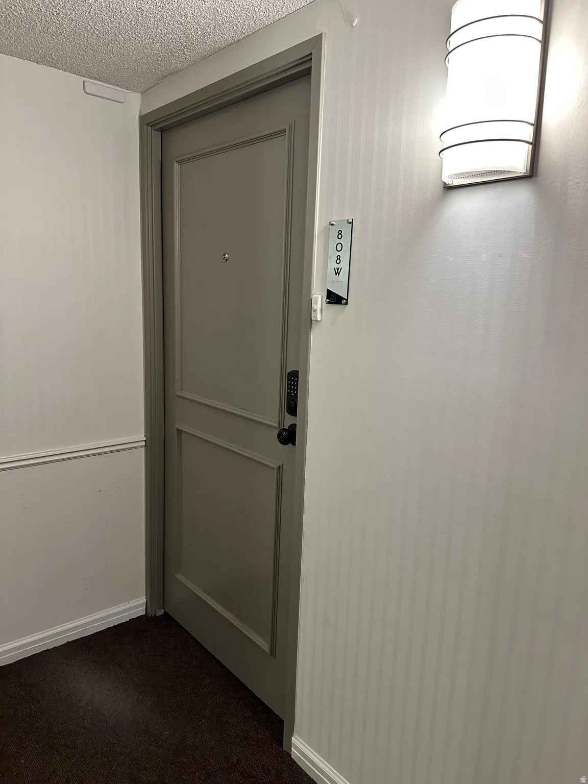 Entry door featuring panel detailing and a digital lock