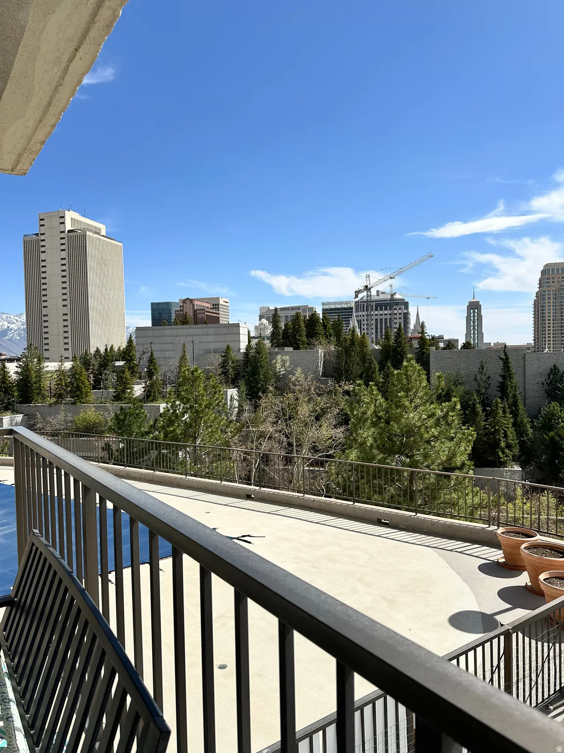 Balcony overlooking a cityscape with distant snow-capped mountains