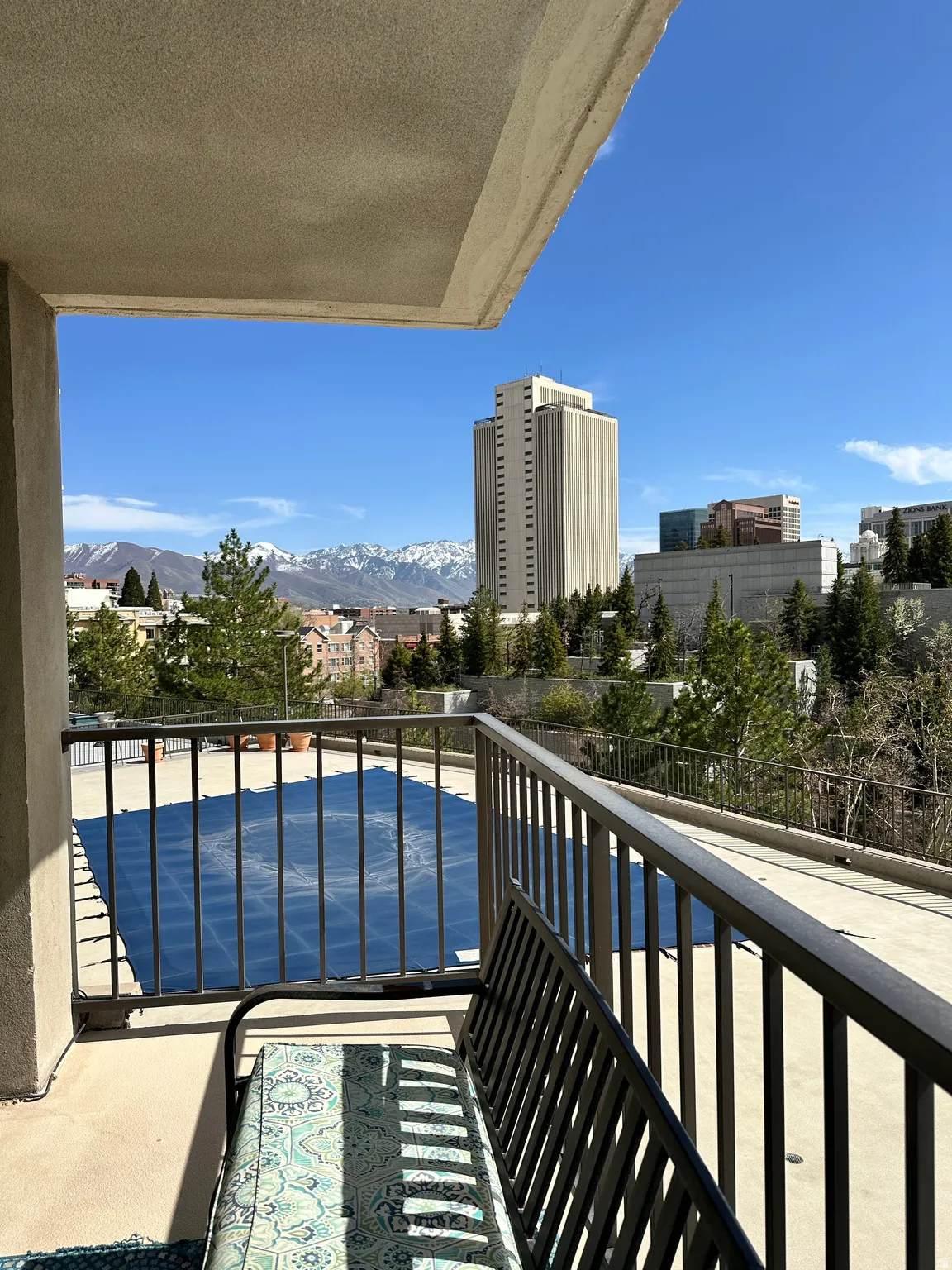 Private balcony featuring a metal railing and stucco exterior