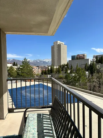 Private balcony featuring a metal railing and stucco exterior