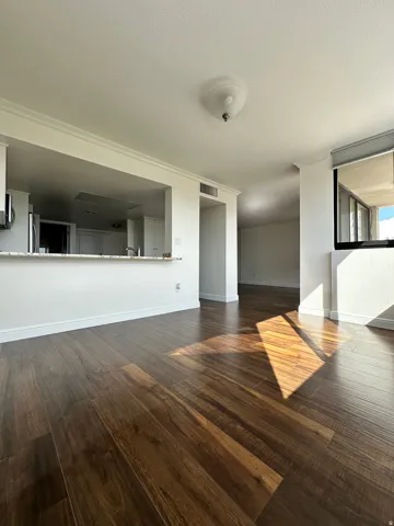 Open-concept living area with dark wood-finish flooring