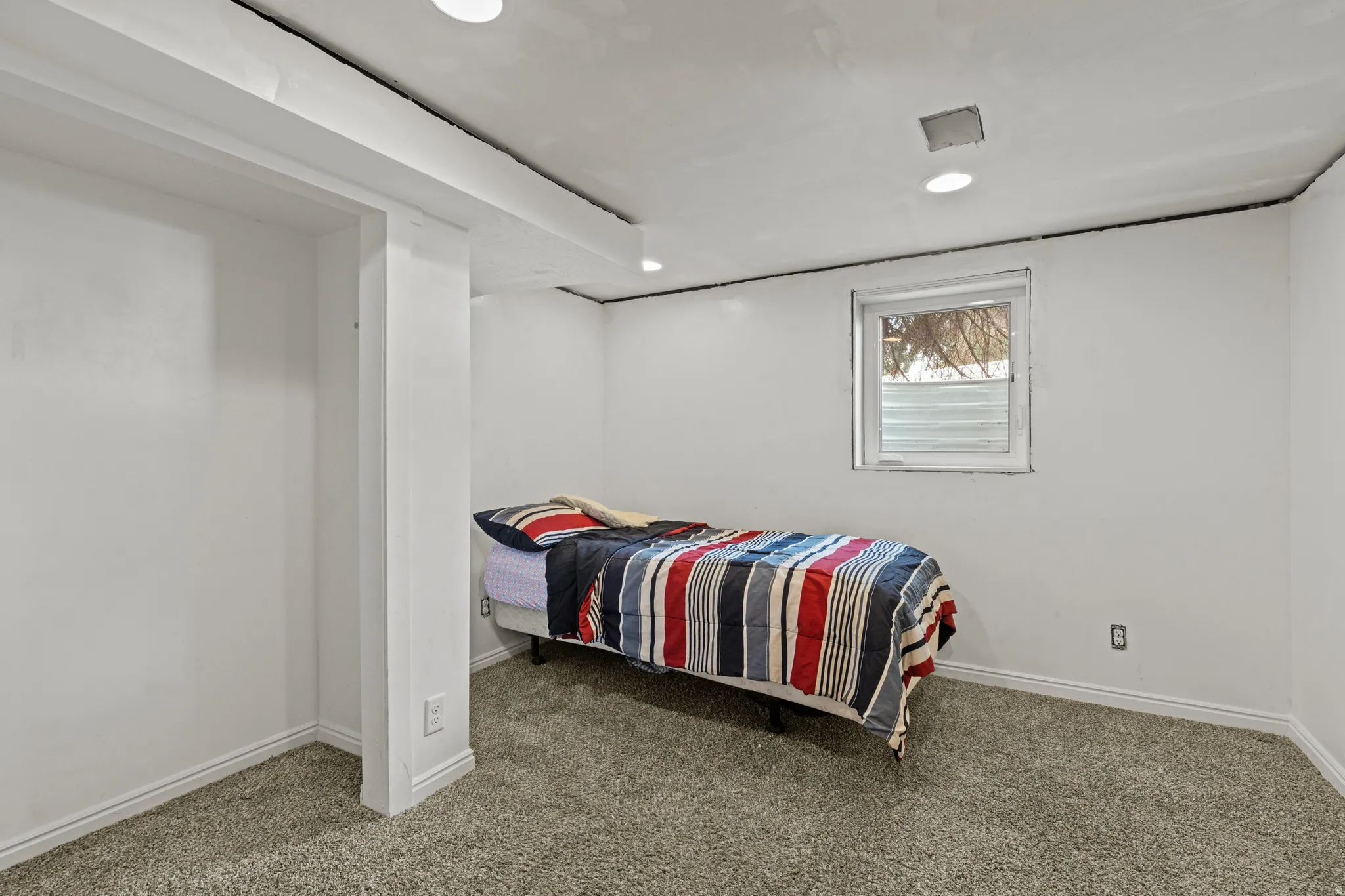 Bedroom featuring a window, recessed lighting, carpeting, and white baseboards