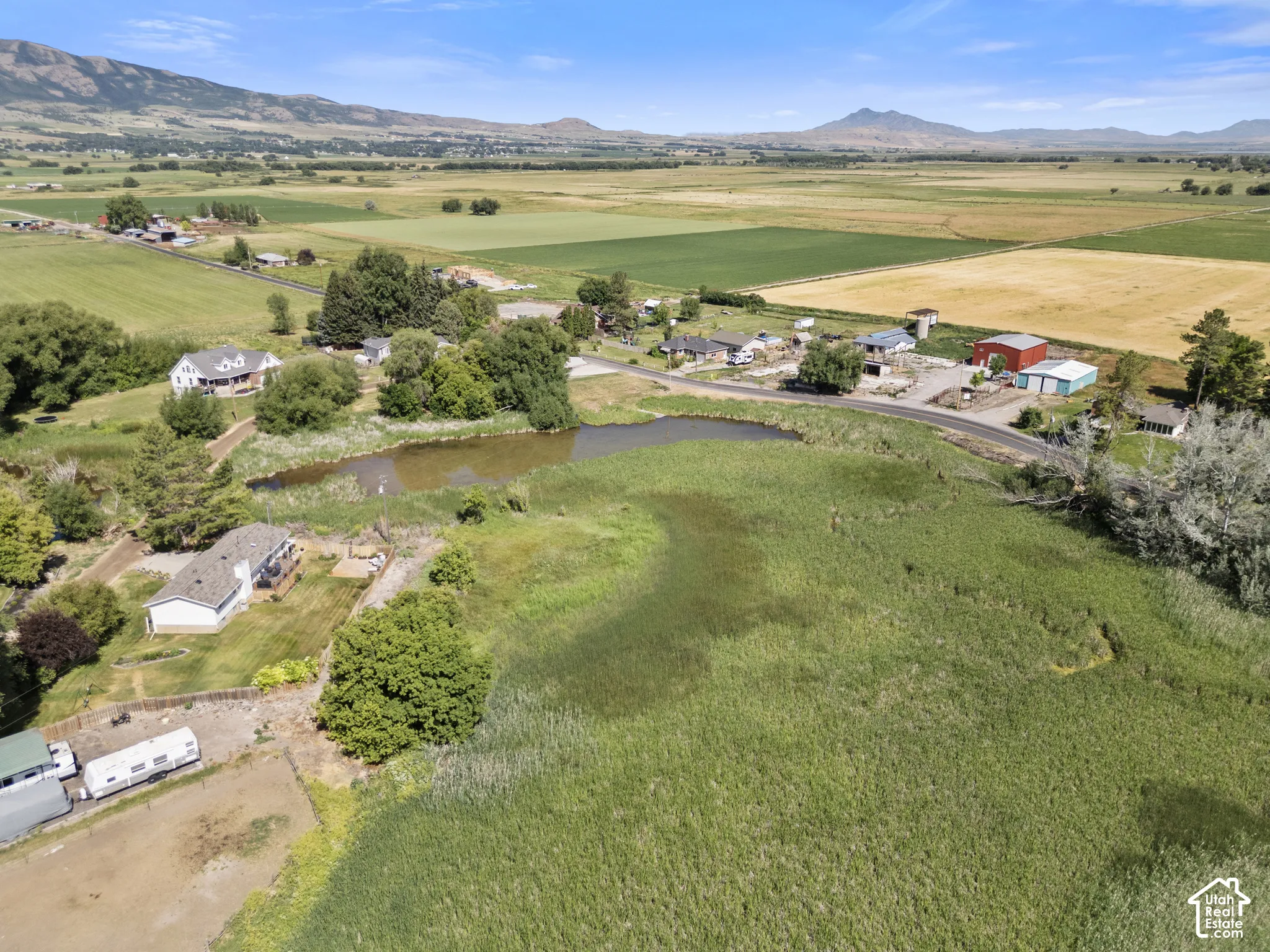 Expansive rural property featuring a large pond surrounded by natural wetlands