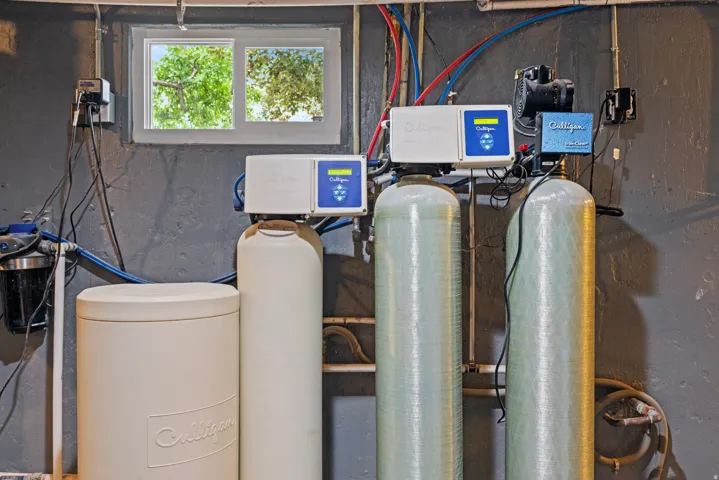 Comprehensive water treatment system featuring multiple tanks, filtration units, and associated plumbing