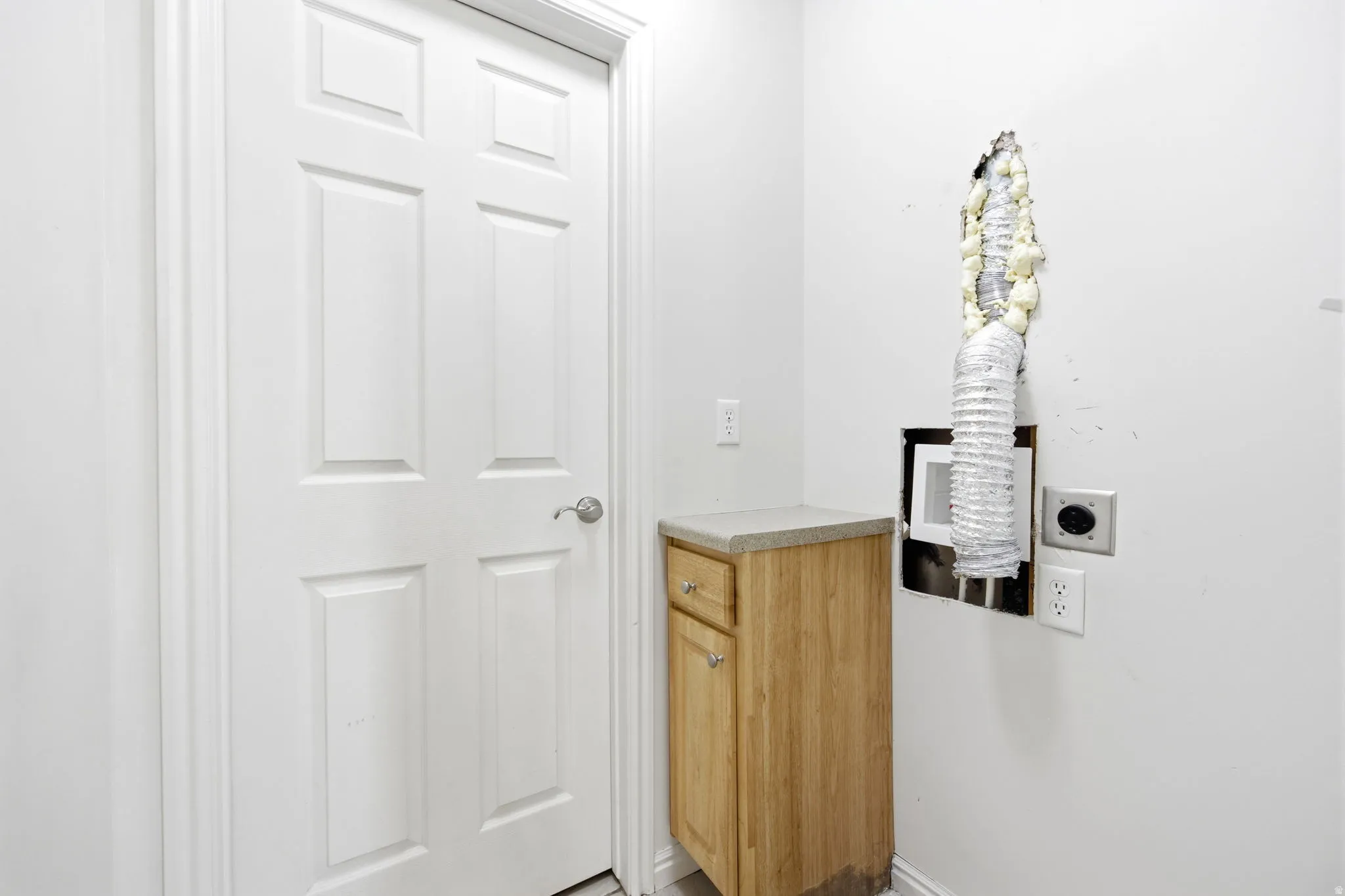 White paneled door with a brushed nickel handle