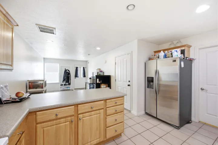 Kitchen featuring wood-finish cabinetry and a light-colored countertop