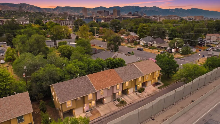 Row of townhomes featuring varied exterior finishes and private garage access