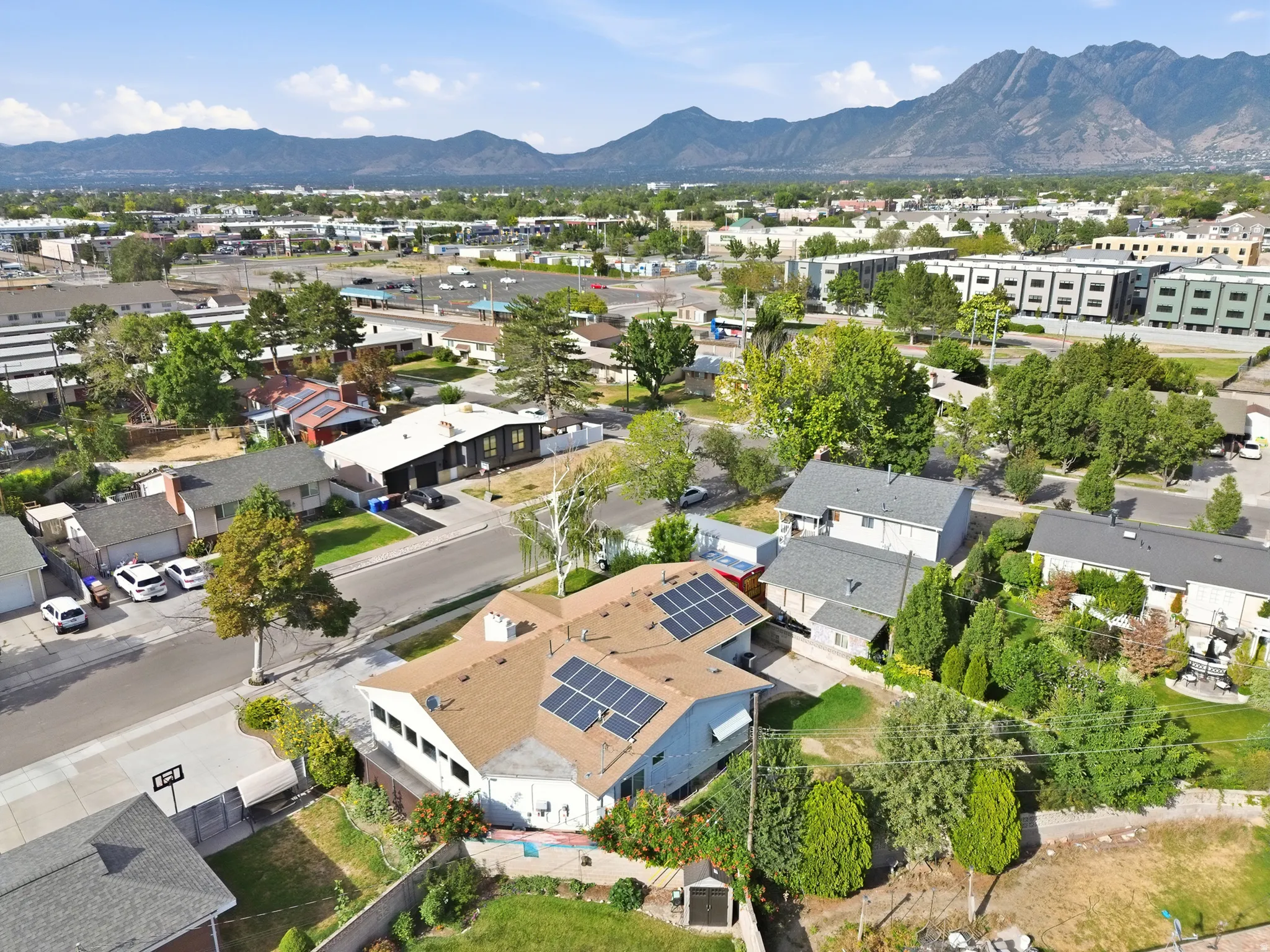 Aerial perspective showcasing a residential property with roof-mounted solar panels