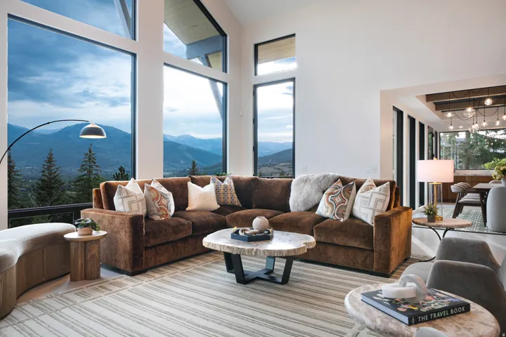 Spacious living area featuring expansive floor-to-ceiling windows, high ceilings, and recessed lighting