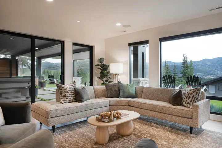 Expansive windows and sliding glass doors, recessed lighting, and wood-finish flooring