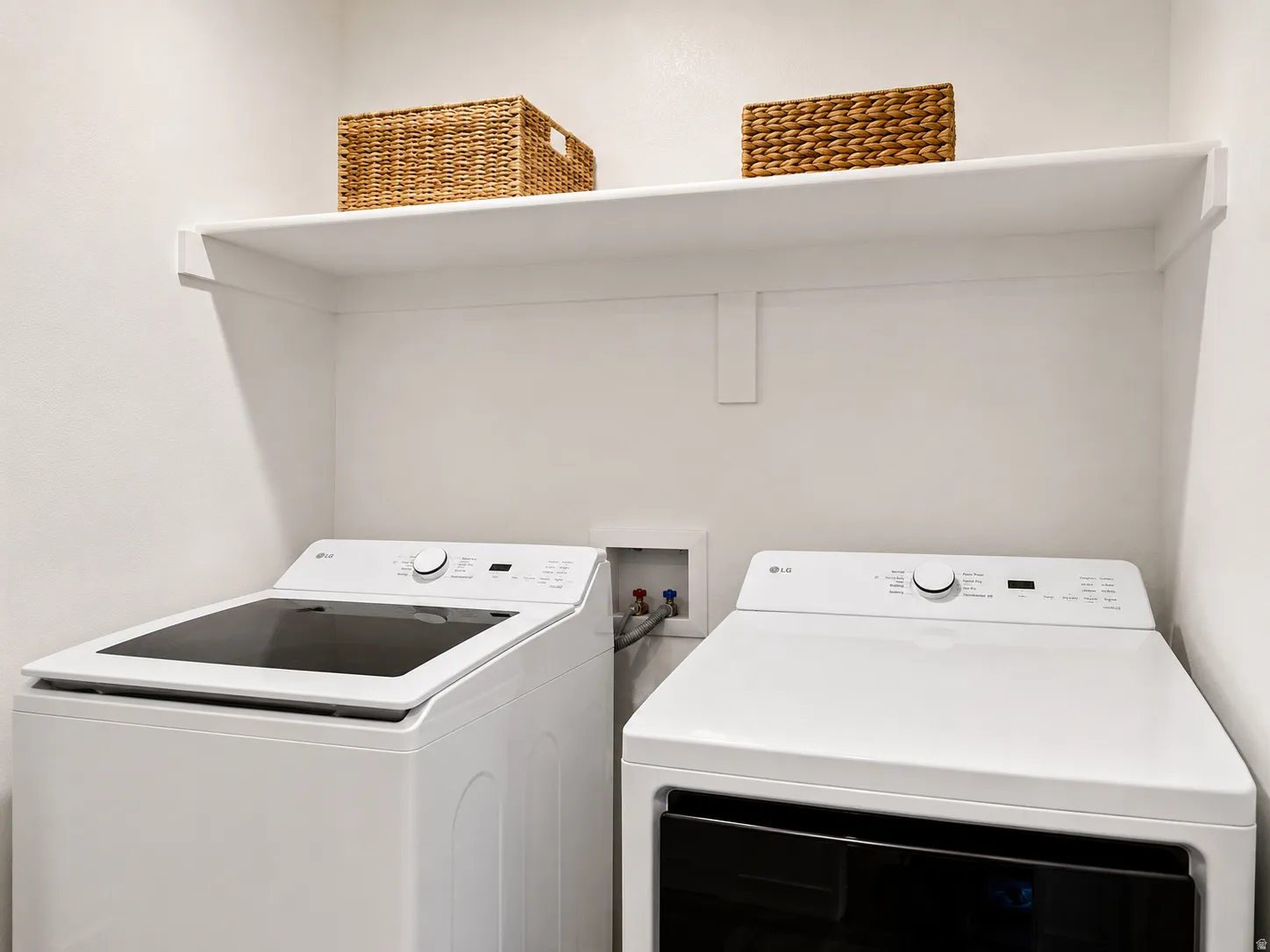 Dedicated laundry area featuring a built-in white shelf