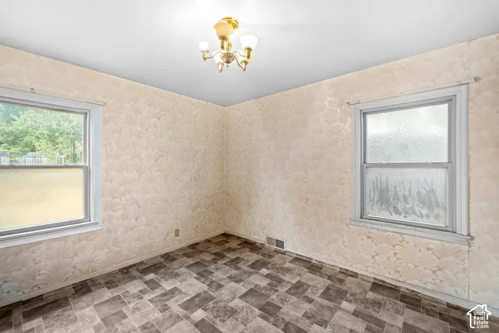 The wallpaper and flooring needs to go but the primary bedroom is spacious and ready for your personal touch.