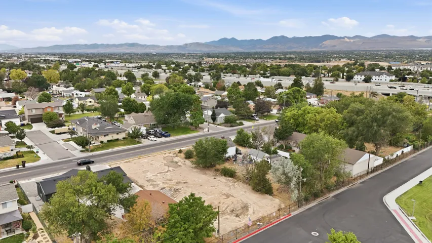 Aerial perspective showcasing a residential neighborhood with distant mountains