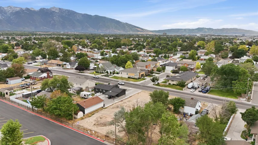 Expansive cleared lot bordered by perimeter fencing, offering direct road access