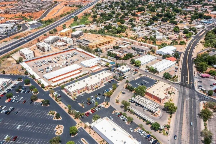 Aerial depiction of a commercial and residential area featuring multiple buildings and roadways