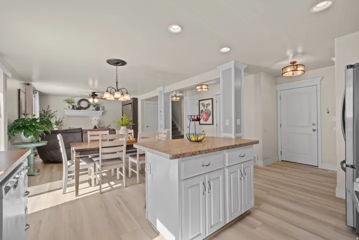 Kitchen island with a granite-style countertop and white cabinetry